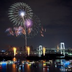 A Fireworks Festival at Tokyo Bay. Rainbow Bridge and Many Japanese style boats are.